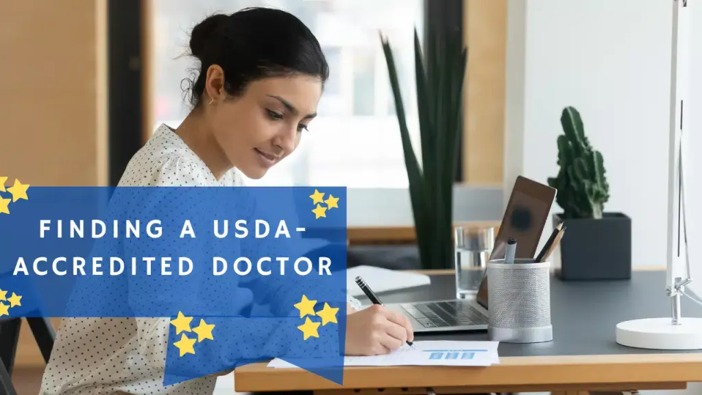 A woman sits at a desk writing notes beside an open laptop, with an overlaid graphic reading ‘Finding a USDA-Accredited Doctor.’
