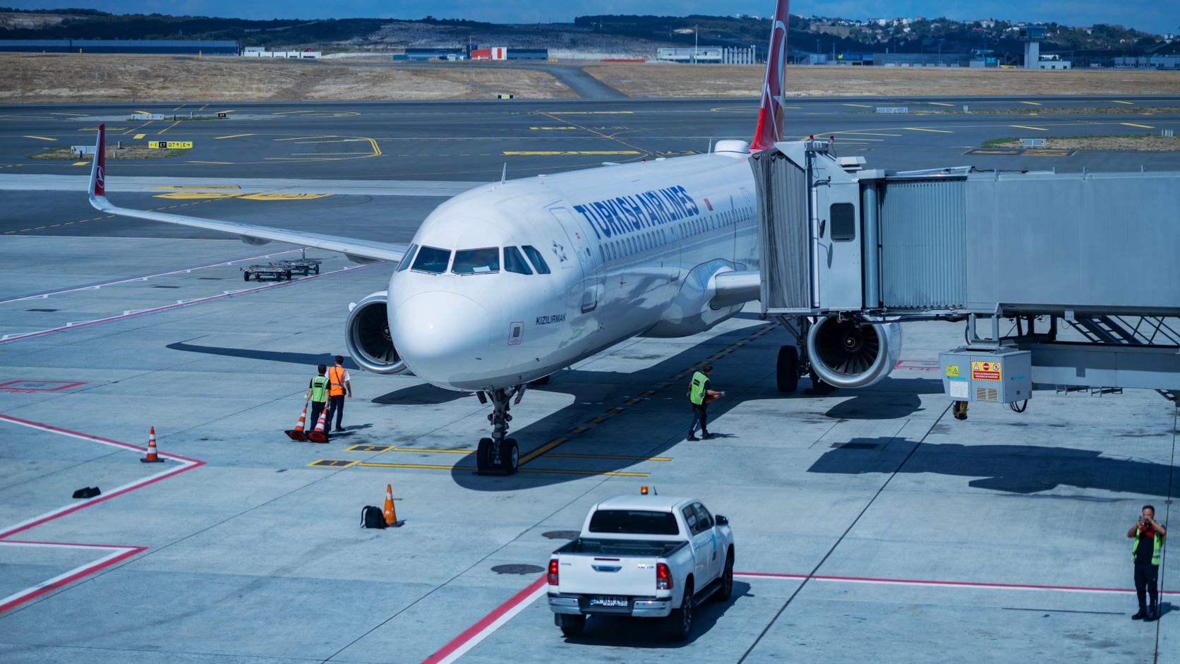 Passenger airplane at an airport gate with ground crew