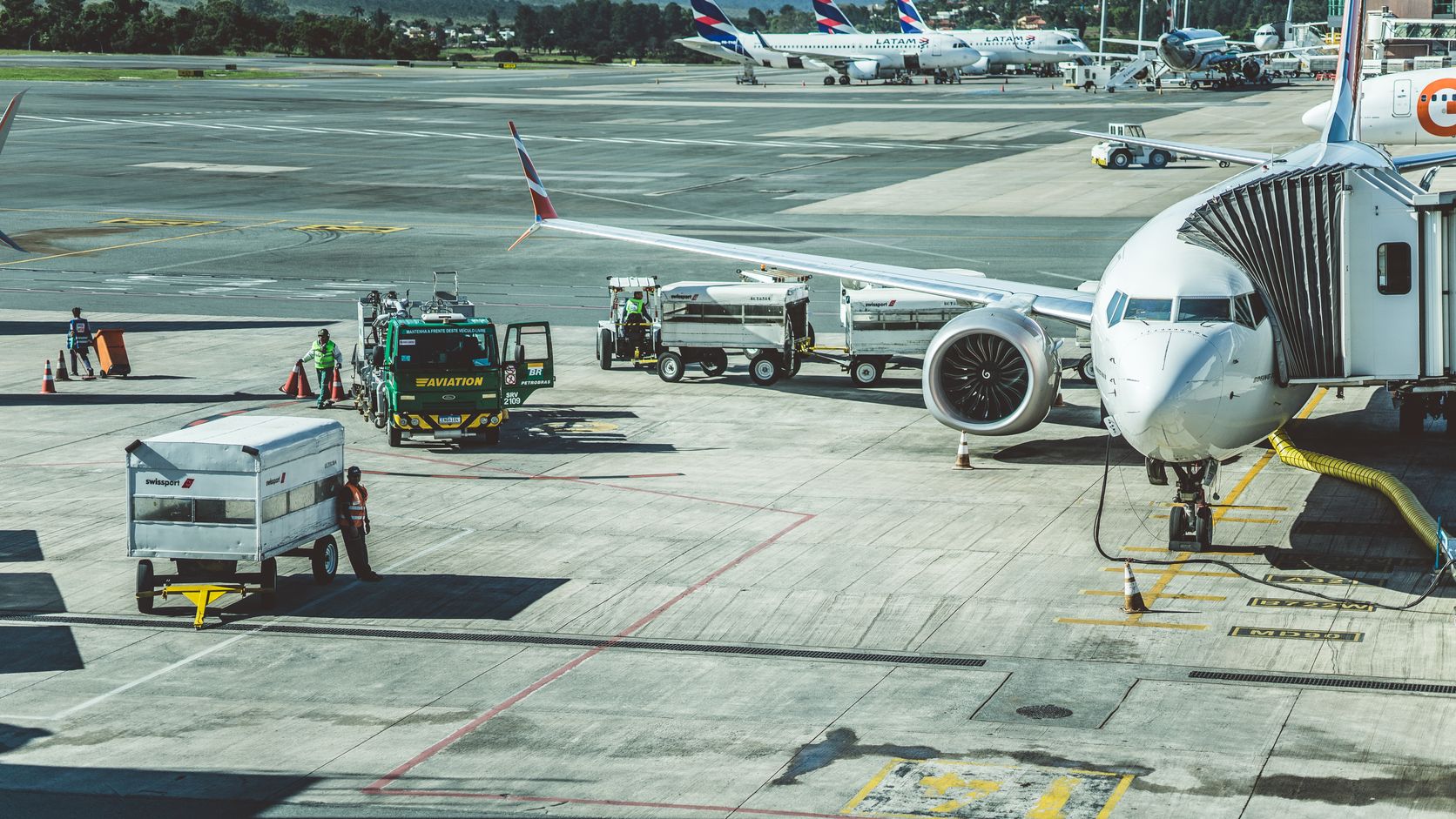 Ground crew preparing a commercial airplane on the airport tarmac
